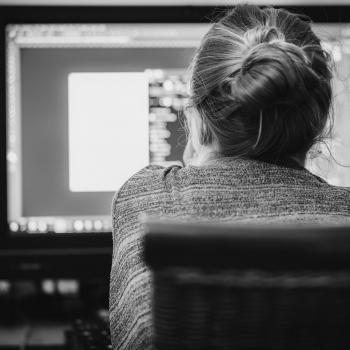 Black and white image of women in front of computer