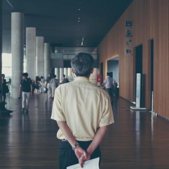 Man standing in a university hallway
