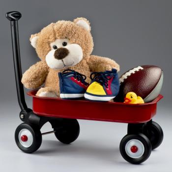 teddy bear, toy football on a red toy wagon