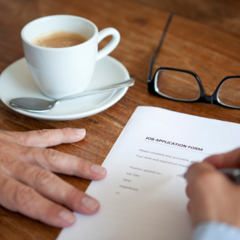 hands of a man filling a job application form